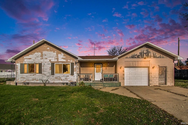 single story home featuring a garage and a yard