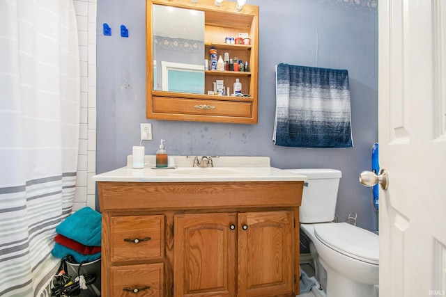 bathroom featuring curtained shower, vanity, and toilet