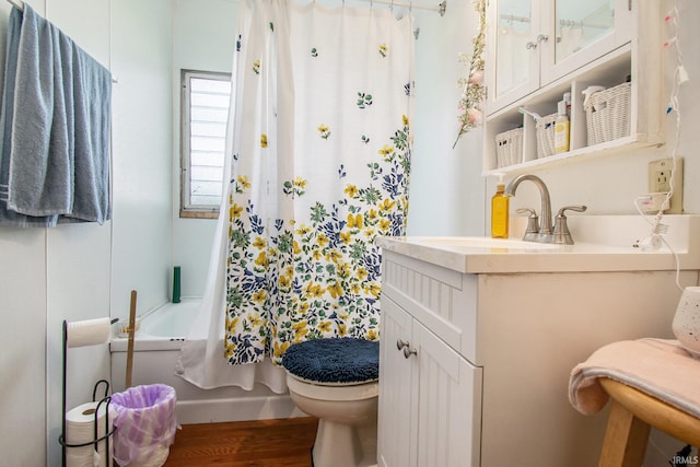 full bathroom with vanity, hardwood / wood-style flooring, toilet, and shower / bathtub combination with curtain