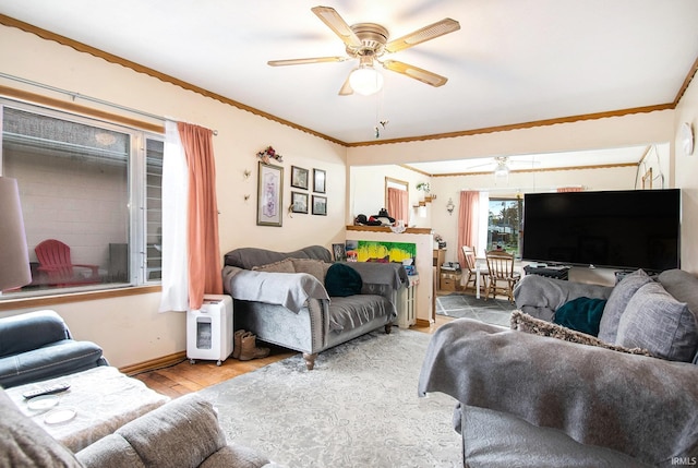 living room featuring light hardwood / wood-style flooring, ceiling fan, and crown molding