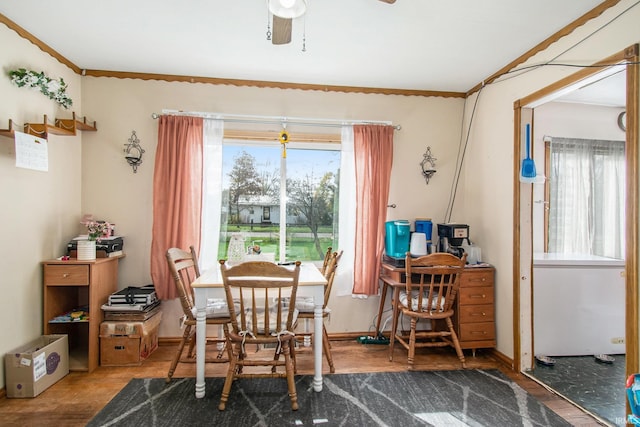 dining space with ornamental molding, wood-type flooring, and ceiling fan