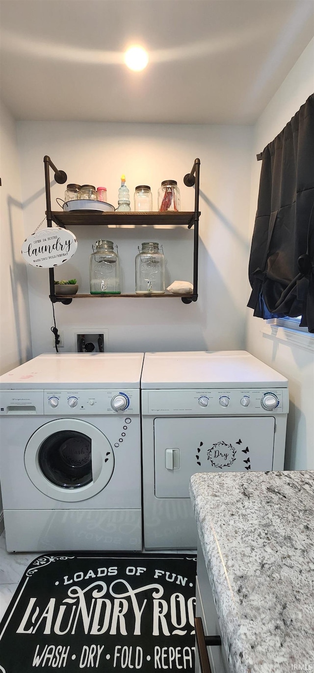 clothes washing area featuring washer and clothes dryer