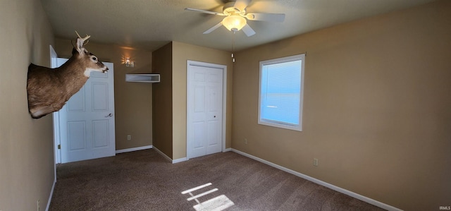 unfurnished bedroom featuring carpet flooring, ceiling fan, and a closet