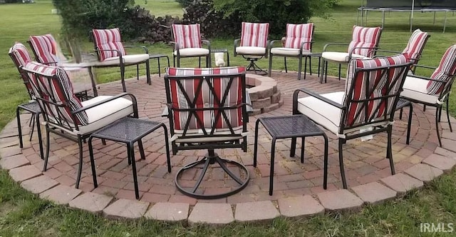 view of patio / terrace with an outdoor fire pit and a trampoline