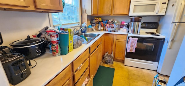 kitchen featuring white appliances and sink