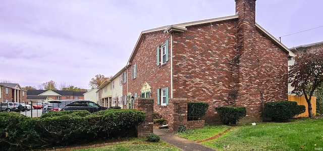 view of home's exterior with a lawn