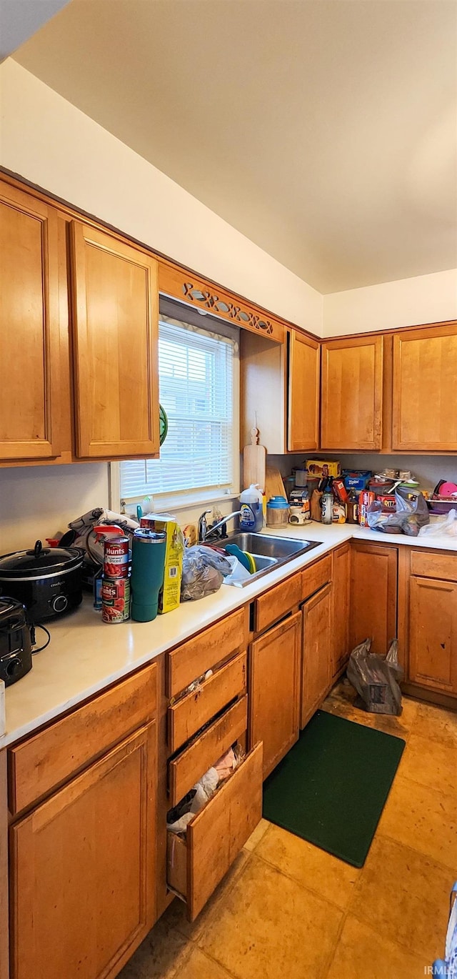 kitchen featuring light tile patterned floors and sink