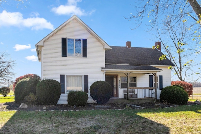 front facade with a front lawn and covered porch