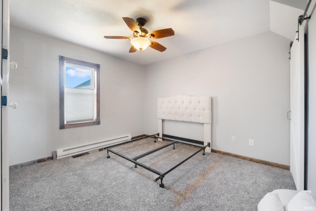 bedroom with a barn door, vaulted ceiling, a baseboard radiator, light colored carpet, and ceiling fan