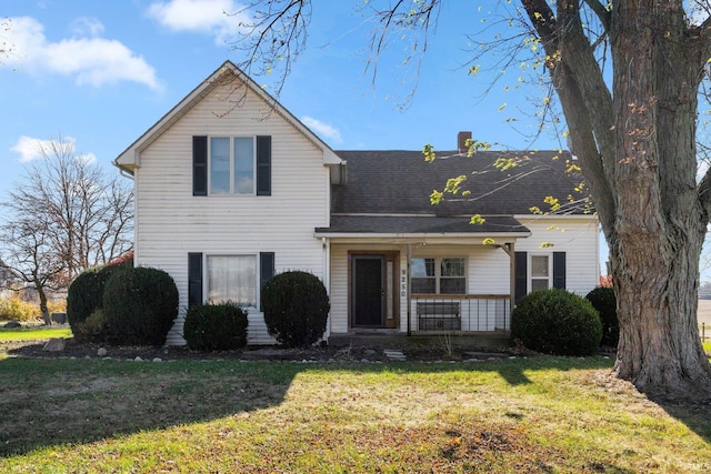 view of front property with covered porch and a front lawn