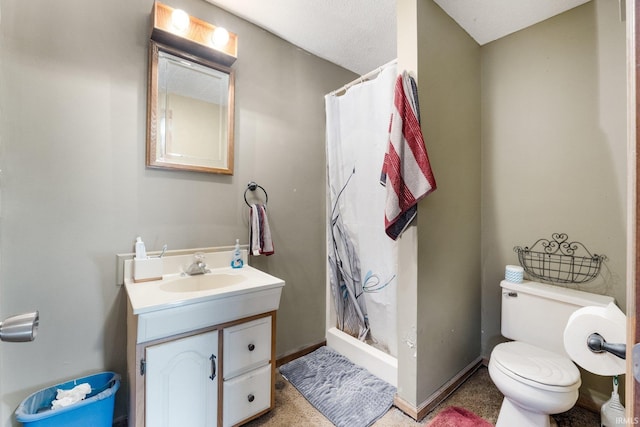 bathroom featuring walk in shower, vanity, a textured ceiling, and toilet