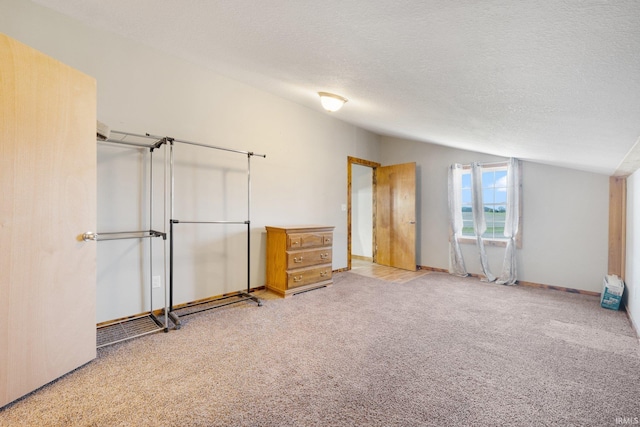 unfurnished bedroom with light colored carpet and a textured ceiling