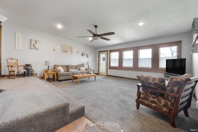 carpeted living room with ceiling fan and a textured ceiling