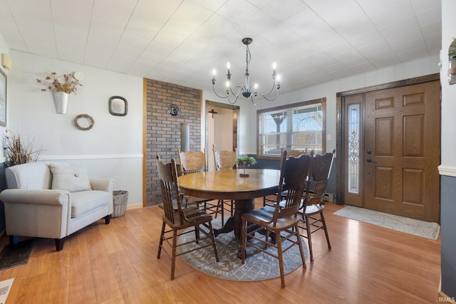 dining room with a chandelier and light hardwood / wood-style flooring