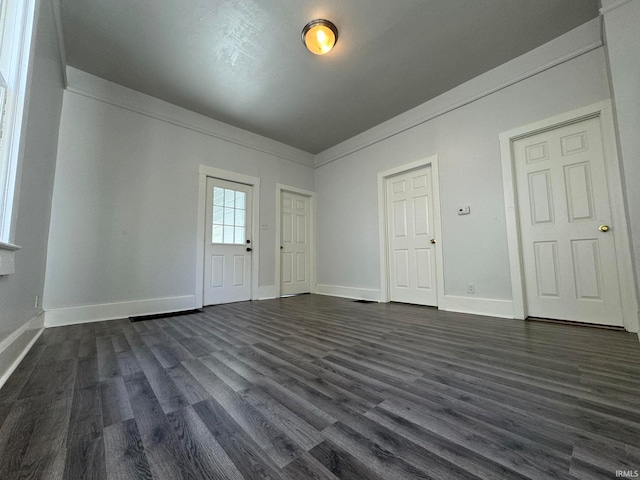 entrance foyer with dark hardwood / wood-style flooring and ornamental molding