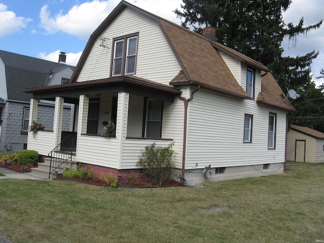 view of front of property with a front lawn and a storage unit