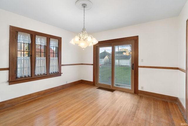 interior space featuring an inviting chandelier and light hardwood / wood-style floors