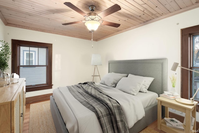 bedroom featuring light wood-type flooring, ceiling fan, crown molding, and wooden ceiling