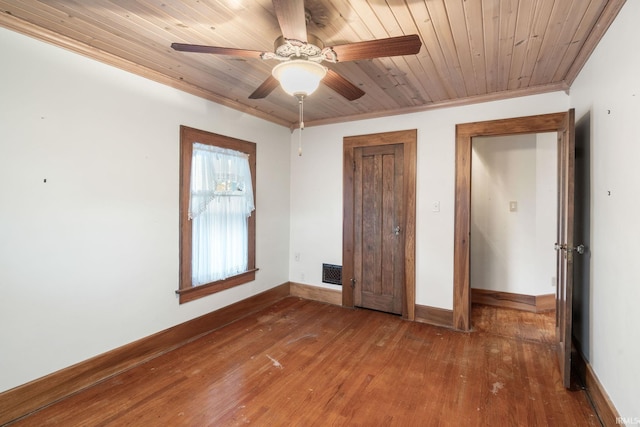 unfurnished bedroom featuring ornamental molding, wood-type flooring, ceiling fan, and wood ceiling