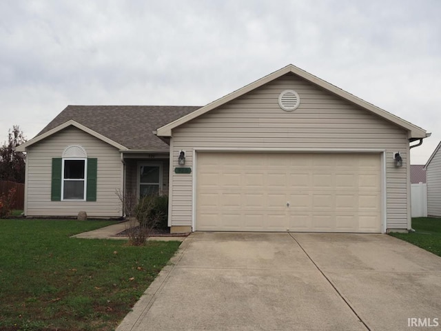 ranch-style home with a garage and a front yard