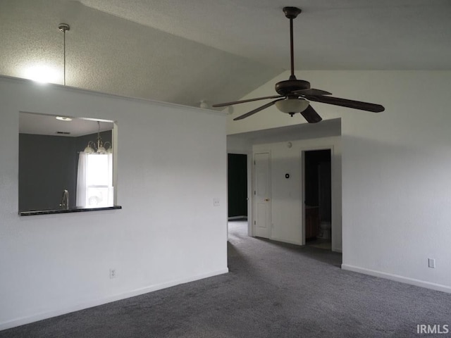 unfurnished room featuring ceiling fan, carpet flooring, and vaulted ceiling