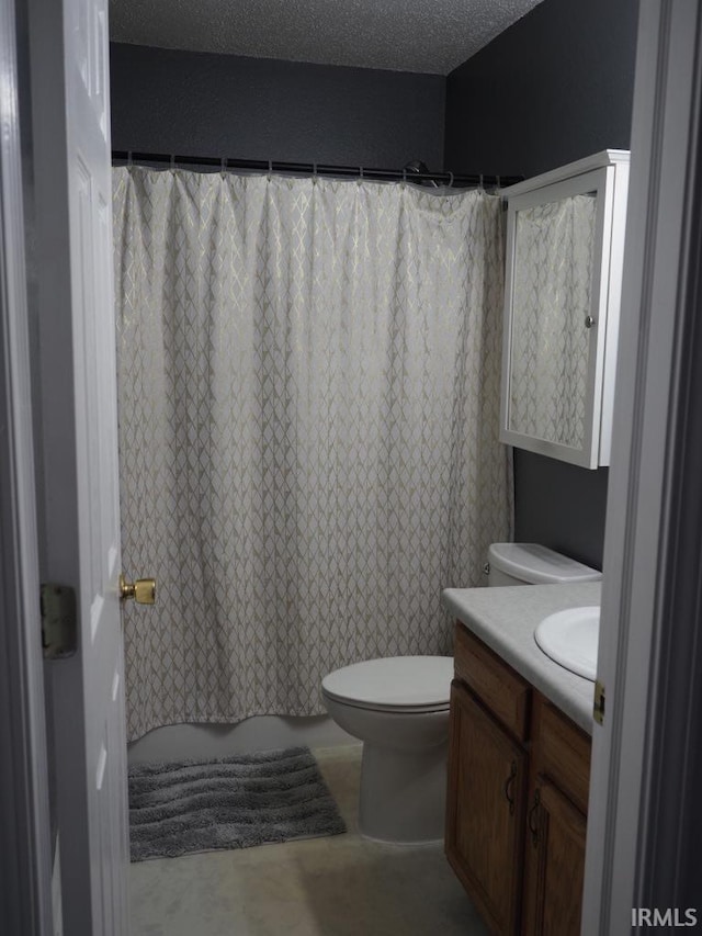 bathroom with toilet, vanity, and a textured ceiling