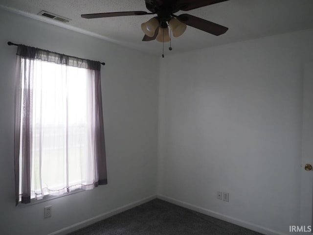 carpeted spare room with ceiling fan