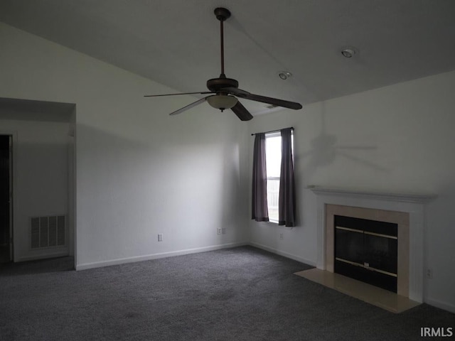 unfurnished living room with ceiling fan, dark colored carpet, and lofted ceiling