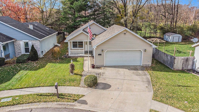 view of front facade featuring a shed, a front lawn, and a garage