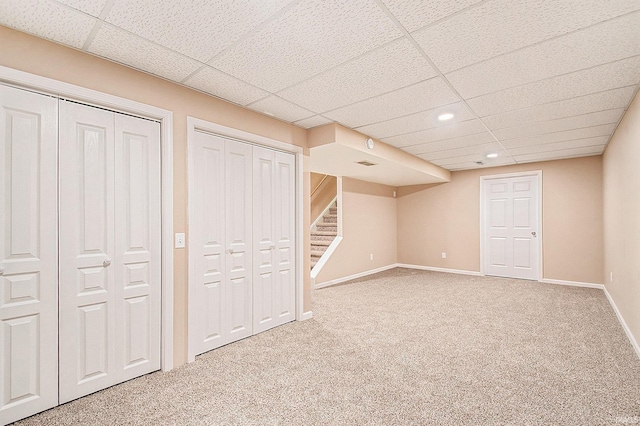 basement with carpet and a drop ceiling