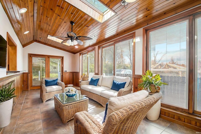 sunroom / solarium featuring lofted ceiling with skylight, ceiling fan, and wooden ceiling