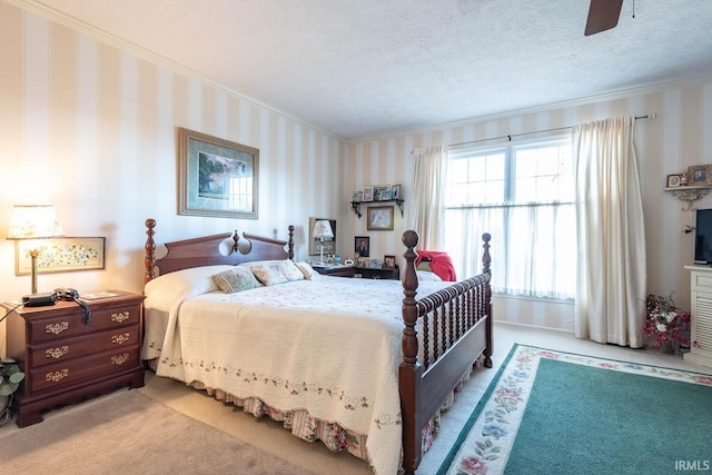 bedroom with ceiling fan, light carpet, a textured ceiling, and ornamental molding