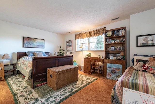 bedroom with carpet and a textured ceiling