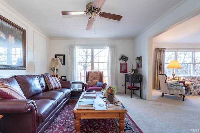 carpeted living room with crown molding, ceiling fan, and a healthy amount of sunlight