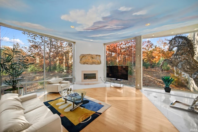 living room with hardwood / wood-style floors and a wall of windows