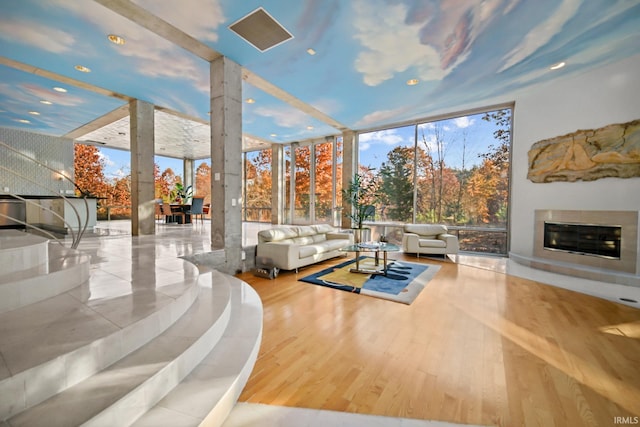 living room with hardwood / wood-style flooring and a wall of windows