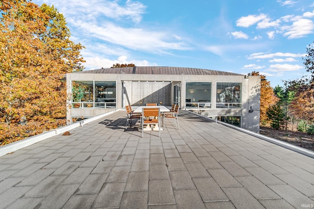 view of patio / terrace featuring a sunroom