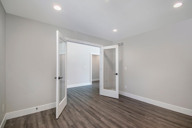 unfurnished bedroom with dark wood-type flooring and french doors