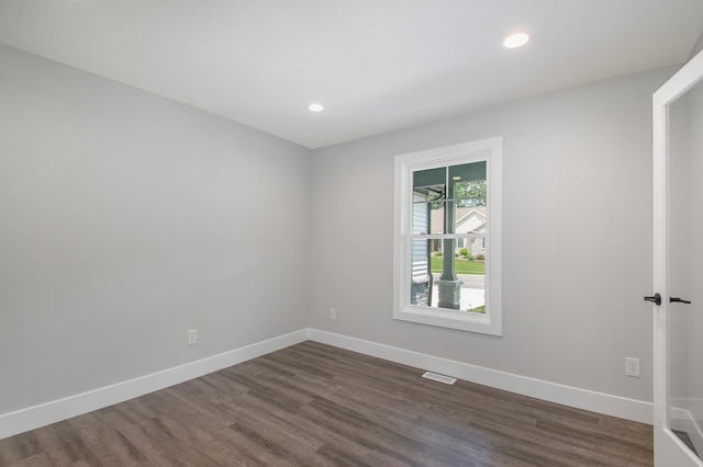 empty room with dark wood-type flooring