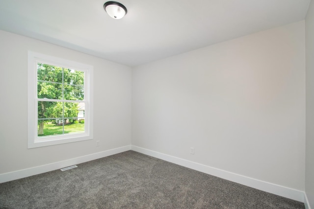 empty room featuring dark carpet