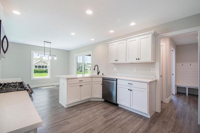 kitchen featuring white cabinetry, dark hardwood / wood-style flooring, kitchen peninsula, decorative light fixtures, and appliances with stainless steel finishes