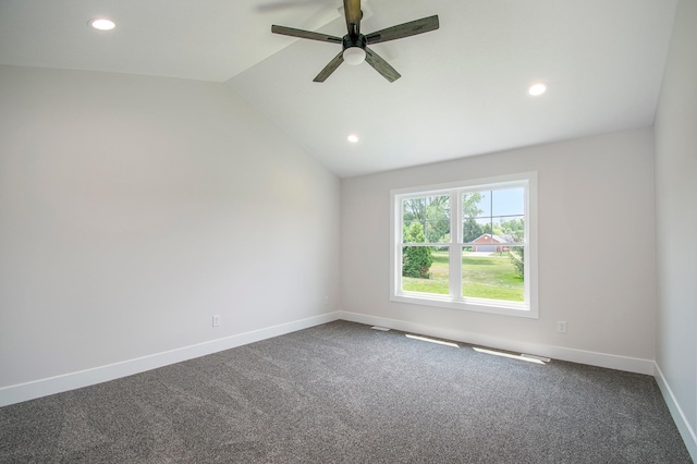 carpeted spare room featuring ceiling fan and lofted ceiling