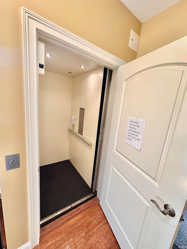 interior space with hardwood / wood-style floors and elevator