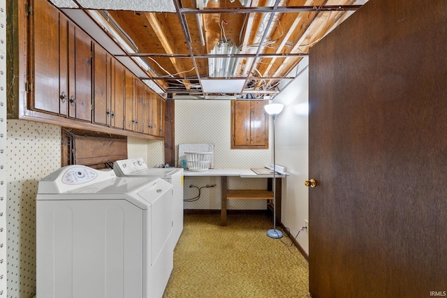 laundry room with washing machine and dryer, cabinets, and light carpet