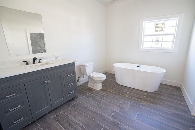 bathroom with vanity, toilet, wood-type flooring, and a bathtub