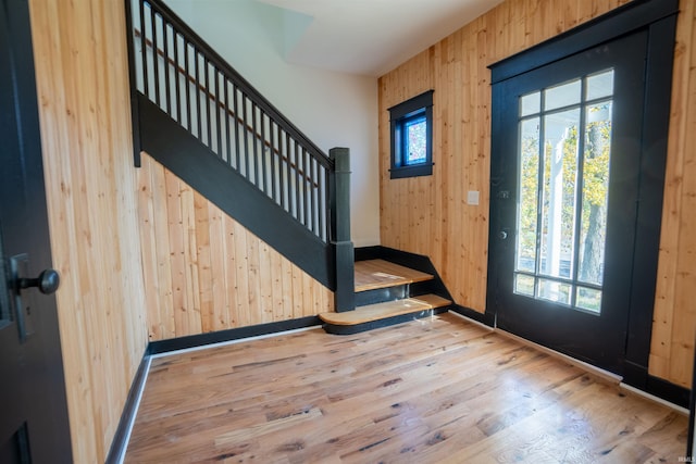 foyer featuring wooden walls and hardwood / wood-style floors