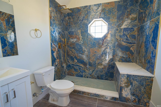 bathroom with vanity, hardwood / wood-style floors, toilet, and a tile shower