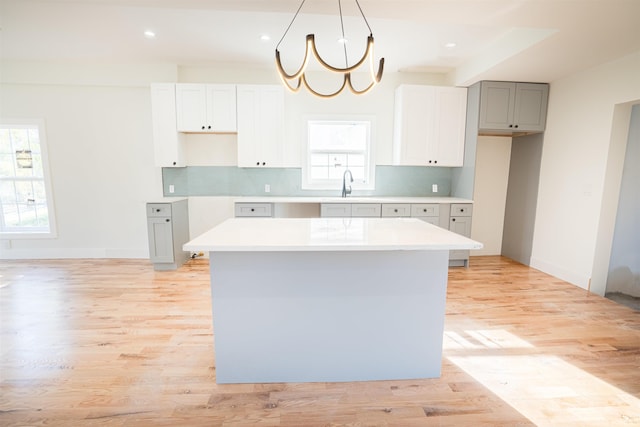 kitchen featuring plenty of natural light, a kitchen island, and light hardwood / wood-style floors