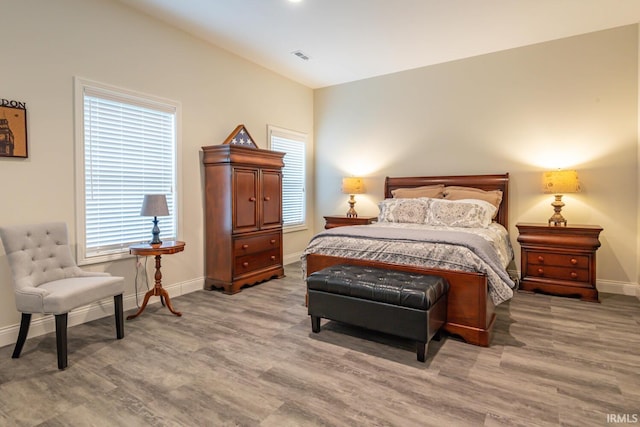 bedroom with hardwood / wood-style flooring