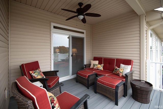 wooden terrace with an outdoor hangout area and ceiling fan